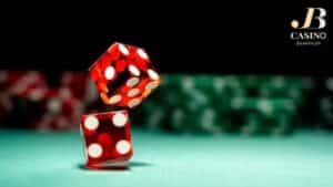 a pair of dice bounced in a sic bo table with a blurred casino chips in the background