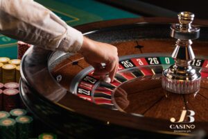 a roulette wheel is being managed by a casino dealer